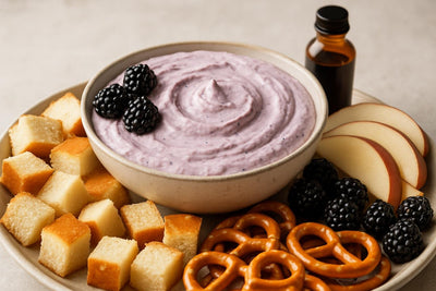 Bowl of blackberry vanilla dip with brioche, pretzels and fruit