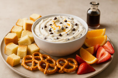 Bowl of cannoli cream dip with brioche, pretzels and fruit