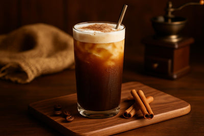 Cinnamon Cold Brew in a glass on an oak serving board