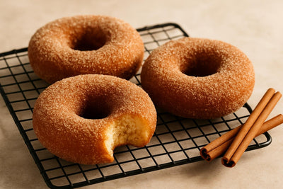 Doughnuts finished with cinnamon sugar on a cooling rack