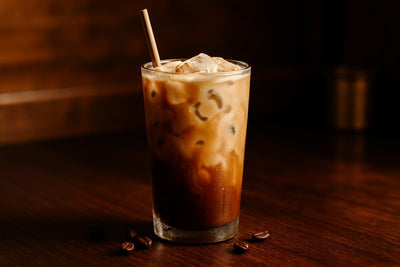 Coffee Milk in a glass on an oak bar