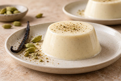 Dairy-Free Cardamom Vanilla Panna Cotta, unmolded on a plate with vanilla beans