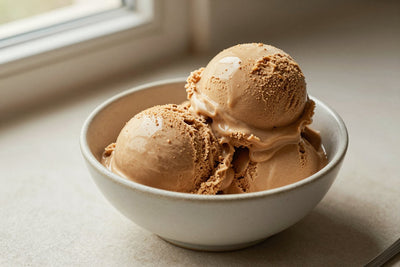 Two generous scoops of espresso ice cream in a shallow ceramic bowl, softly melting at the edges