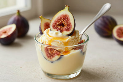 A generous swirl of fig gelato in a small glass cup with a flat gelato spade