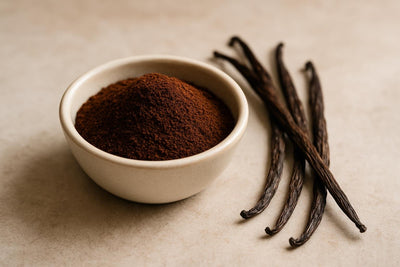 Bowl of homemade vanilla powder beside dried vanilla pods