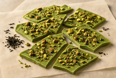 Shards of matcha pistachio bark on parchment