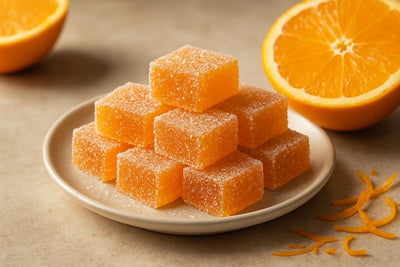 Squares of orange fruit jellies rolled in sugar