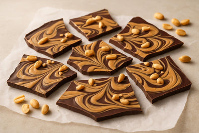 Shards of peanut butter swirl bark on parchment