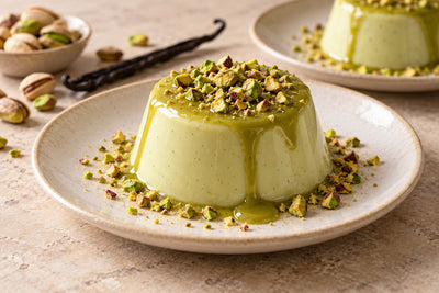 Pistachio Vanilla Panna Cotta, unmolded on a plate with vanilla beans