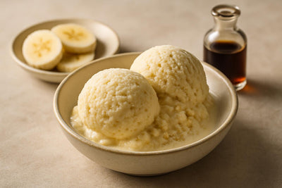 Scoops of vanilla banana ginger custard ice cream in a ceramic bowl