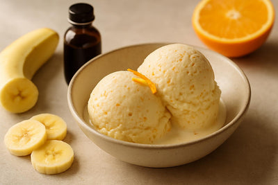 Scoops of vanilla banana orange custard ice cream in a ceramic bowl