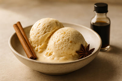 Scoops of vanilla chai spice orange custard ice cream in a ceramic bowl