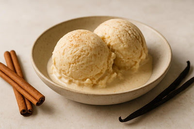 Scoops of vanilla cinnamon custard ice cream in a ceramic bowl