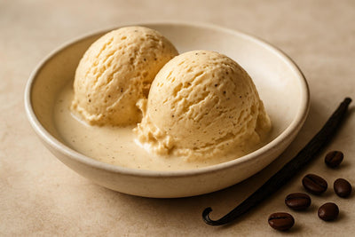 Scoops of vanilla espresso cardamom custard ice cream in a ceramic bowl