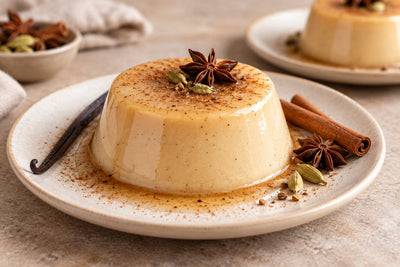 Vegan Chai Vanilla Panna Cotta, unmolded on a plate with vanilla beans