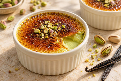 Vegan Pistachio Vanilla Crème Brûlée in a ramekin with a caramelized sugar crust