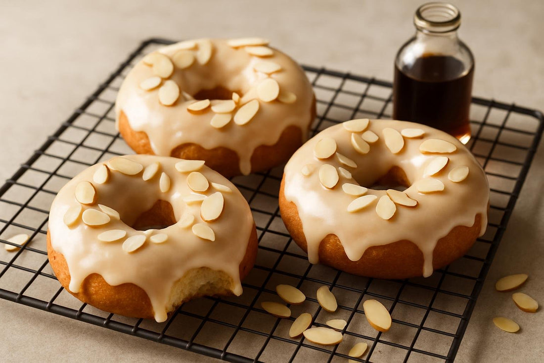 Doughnuts finished with almond glaze on a cooling rack