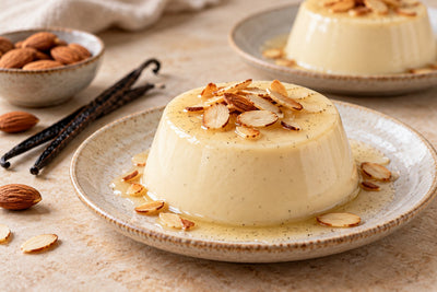 Almond Vanilla Panna Cotta, unmolded on a plate with vanilla beans