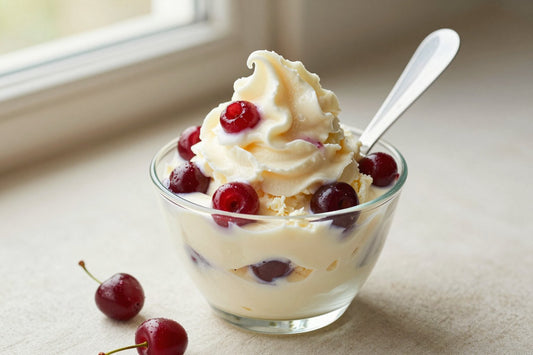 A generous swirl of amarena cherry-style gelato in a small glass cup with a flat gelato spade