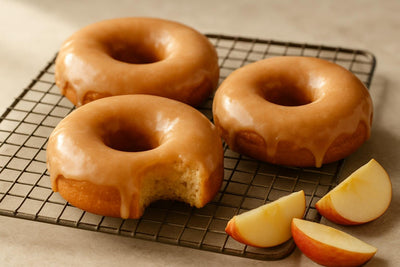 Doughnuts finished with apple cider glaze on a cooling rack