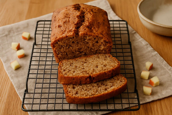 Apple Cinnamon Bread loaf with sliced pieces on an oak board
