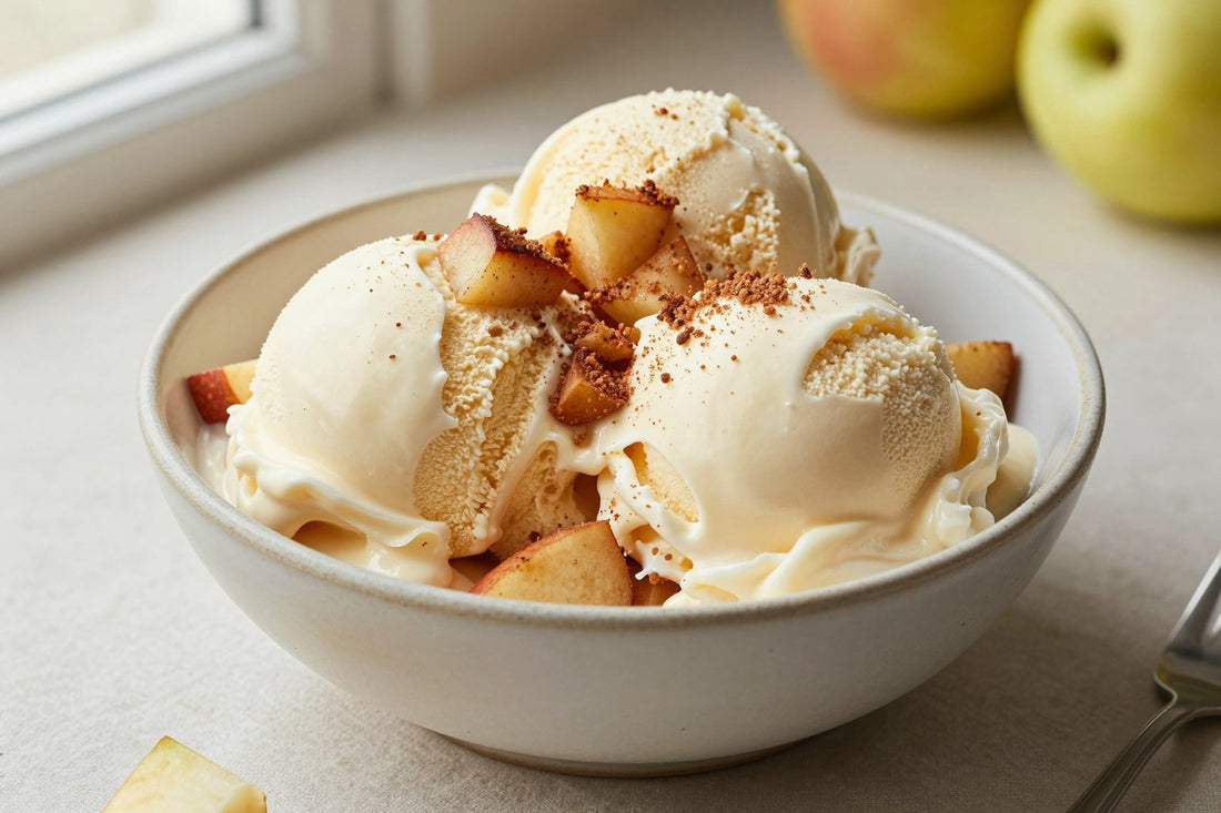 Two generous scoops of apple pie ice cream in a shallow ceramic bowl, softly melting at the edges