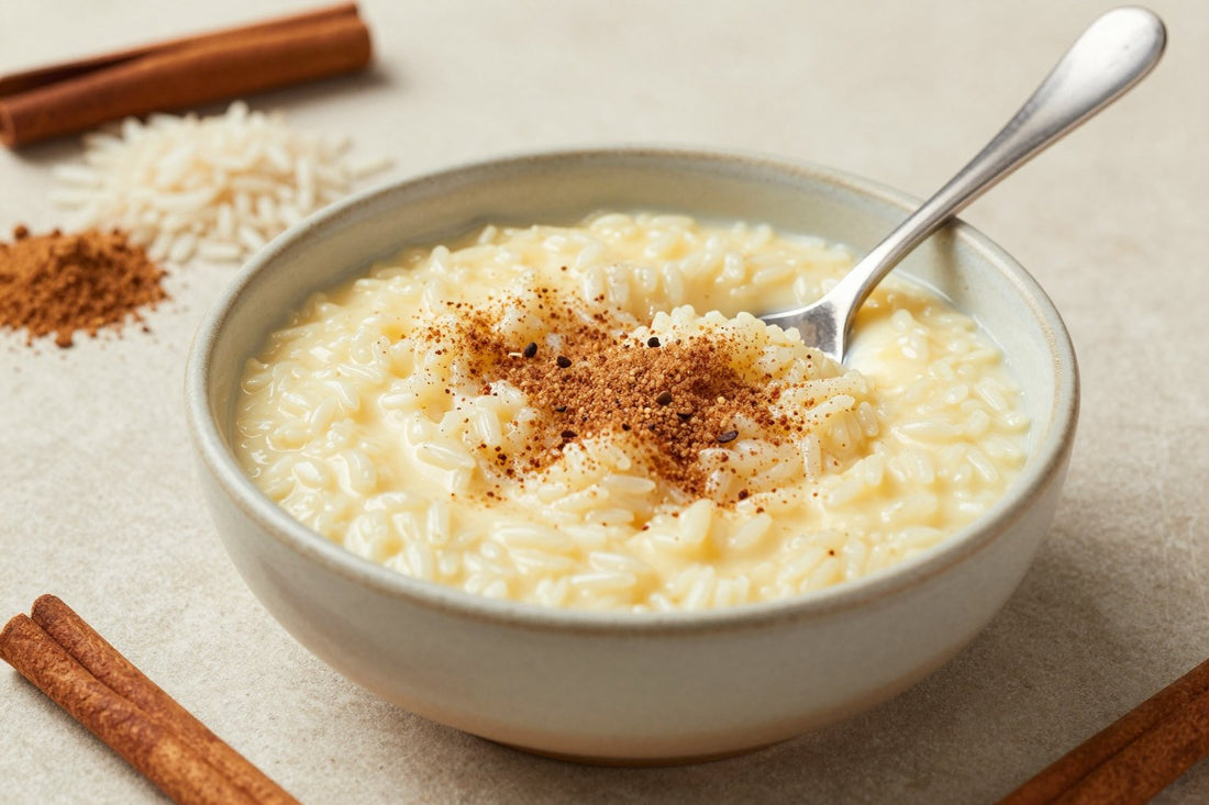 Creamy arroz con leche in a small ceramic bowl with a spoon, garnished as in the recipe