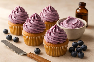 Cupcakes piped with blueberry buttercream frosting