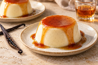 Bourbon Vanilla Panna Cotta, unmolded on a plate with vanilla beans