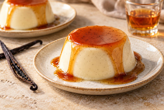 Bourbon Vanilla Panna Cotta, unmolded on a plate with vanilla beans