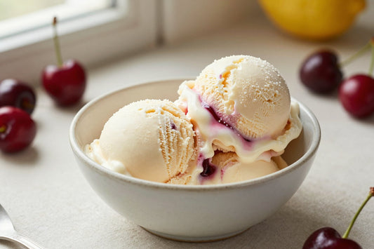 Two generous scoops of cherry vanilla ice cream in a shallow ceramic bowl, softly melting at the edges