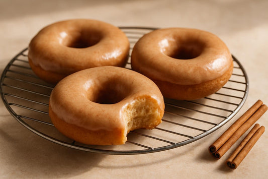 Doughnuts finished with cinnamon glaze on a cooling rack