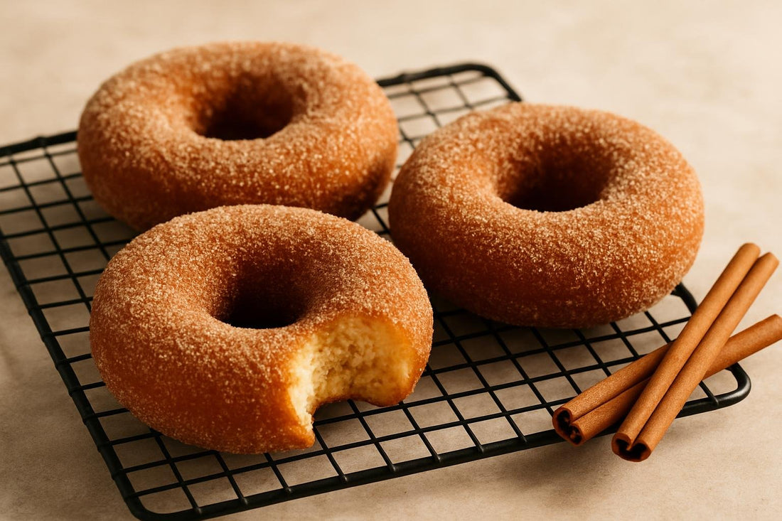Doughnuts finished with cinnamon sugar on a cooling rack