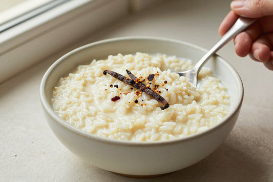Creamy classic creamy rice pudding in a small ceramic bowl with a spoon, garnished as in the recipe