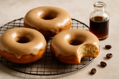 Doughnuts finished with coffee glaze on a cooling rack