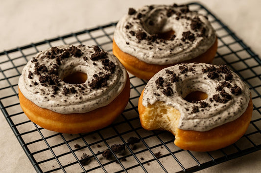 Doughnuts finished with cookies and cream frosting on a cooling rack