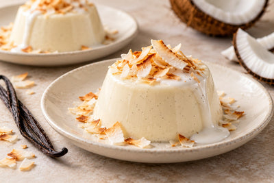 Dairy-Free Coconut Vanilla Panna Cotta, unmolded on a plate with vanilla beans