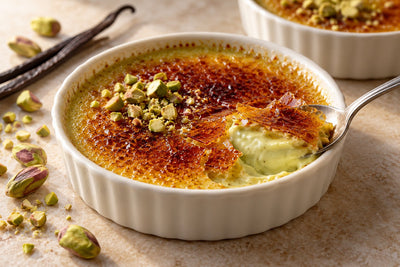 Dairy-Free Pistachio Vanilla Crème Brûlée in a ramekin with a caramelized sugar crust