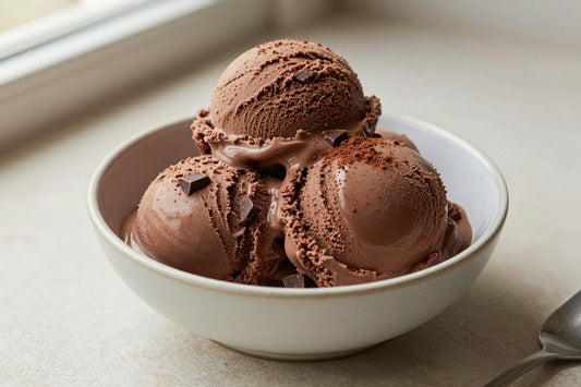 Two generous scoops of double chocolate ice cream in a shallow ceramic bowl, softly melting at the edges