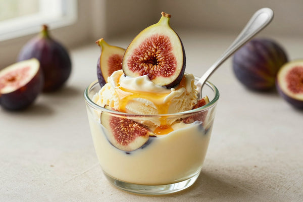 A generous swirl of fig gelato in a small glass cup with a flat gelato spade