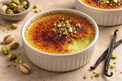 Gluten-Free Pistachio Vanilla Crème Brûlée in a ramekin with a caramelized sugar crust