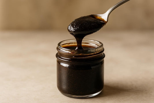 Jar of homemade vanilla bean paste with a spoon