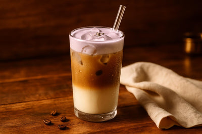 Iced Lavender Latte in a glass on an oak table