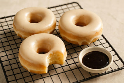Doughnuts finished with Madagascar vanilla glaze on a cooling rack