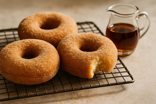 Doughnuts finished with maple sugar dusting on a cooling rack