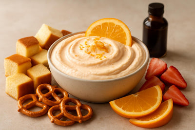 Bowl of orange creamsicle dip with brioche, pretzels and fruit