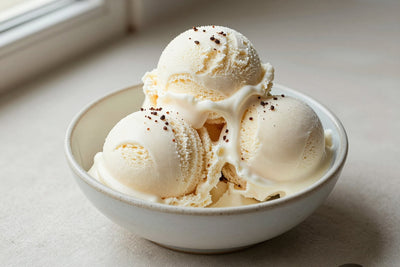 Two generous scoops of peppermint ice cream in a shallow ceramic bowl, softly melting at the edges