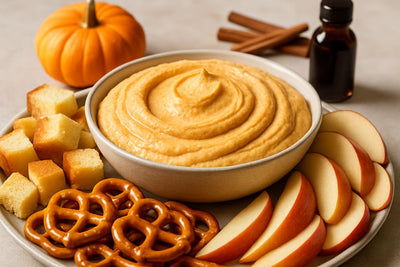 Bowl of pumpkin cheesecake dip with brioche, pretzels and fruit