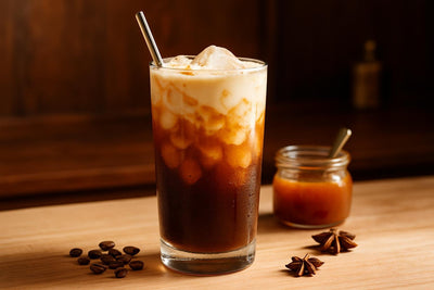 Salted Caramel Cold Brew in a glass on an oak kitchen island