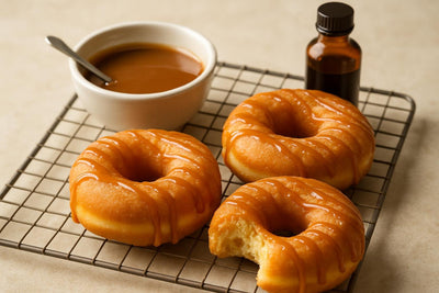 Doughnuts finished with salted caramel drizzle on a cooling rack